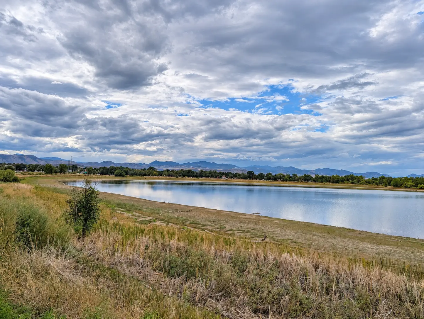 Crown Hill Lake with trees and mountains beyond