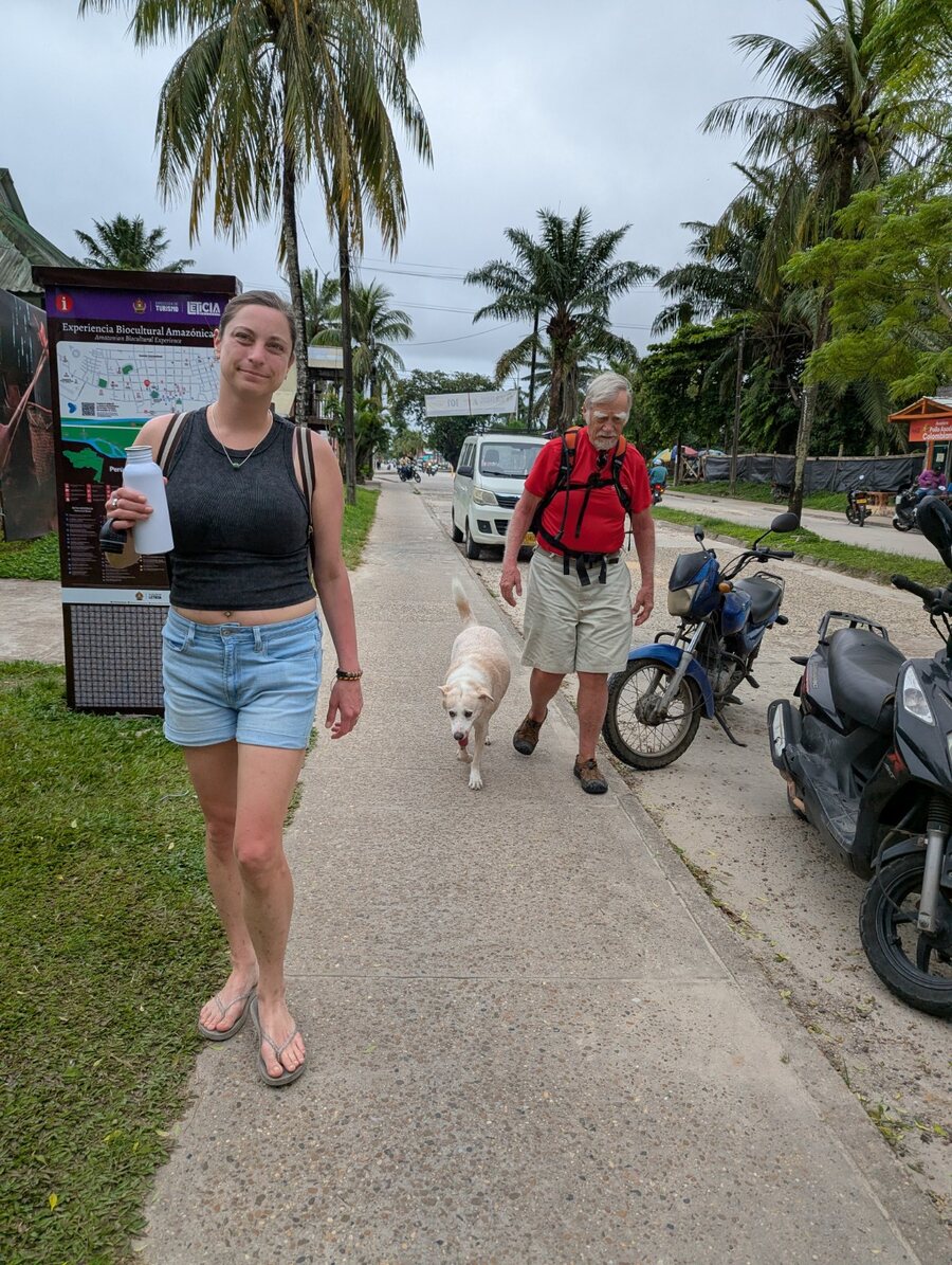 Travelers walking along a street in Leticia, Colombia
